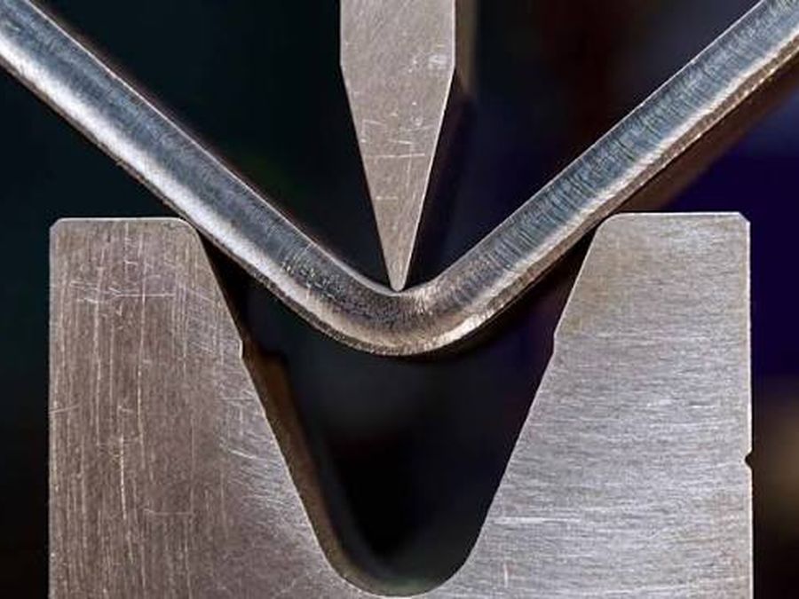 Steel bar formed to a sharp angle in a press brake V-die